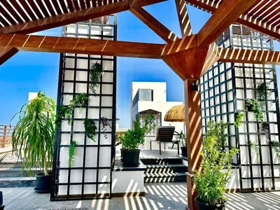 a pergola with potted plants on a patio at Imperial Resort Hurghada-The Hurghada Hideaway in Hurghada