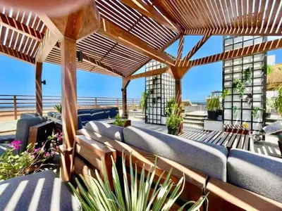 an outdoor patio with benches and a wooden pergola at Imperial Resort Hurghada-The Hurghada Hideaway in Hurghada