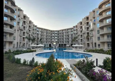 a large apartment building with a large swimming pool at Princess resort in Hurghada