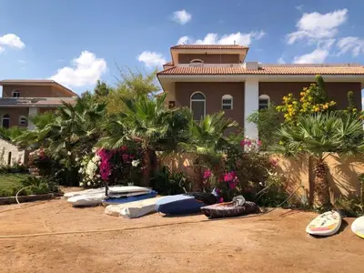 a bunch of surfboards are lined up in front of a house at Turtle beach apartment in Hurghada