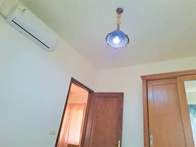 a room with a ceiling with a light and a door at 2 bedroom modern flat at Makadi heights in Hurghada