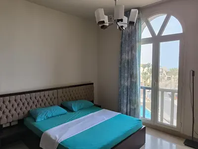 a bedroom with a bed with a large window at Roof top apartment with panorama view in Hurghada