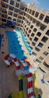 a hotel with a swimming pool and a resort at Juliana resort beach - Julia apartment in Hurghada