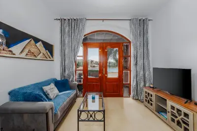 a living room with a blue couch and a tv at 3-Bedroom Apartment - Great location- Upper Nubia in Hurghada