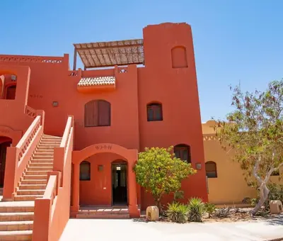 an orange building with stairs in front of it at 3-Bedroom Apartment - Great location- Upper Nubia in Hurghada