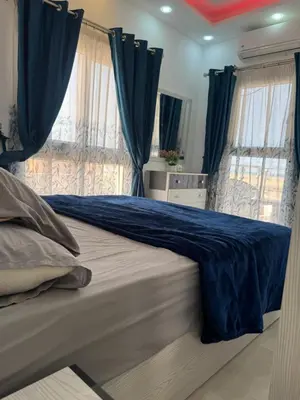 a bedroom with blue curtains and a large bed at Inter Prime apartment 3 in Hurghada