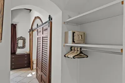 a room with white walls and a hallway with shelves at The Seafront Magical Loft! in Hurghada