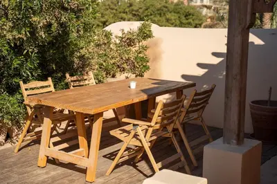 a wooden table and chairs on a patio at The Seafront Magical Loft! in Hurghada