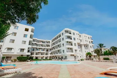 a large white apartment building with a swimming pool at Makramia 2 bedroom apartment in Hurghada