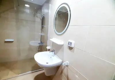a white bathroom with a sink and a mirror at Joka Aldau Heights in Hurghada