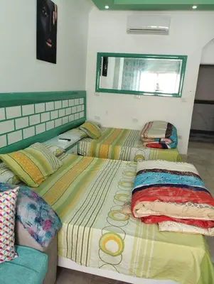 a bedroom with two beds and a couch at plaza hurgahda in Hurghada