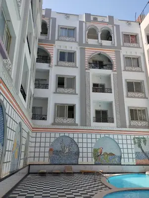 a building with a swimming pool in front of a building at plaza hurgahda in Hurghada