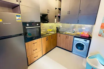 a kitchen with a washer and a washing machine at Cozy 3 bedrooms in swan lake in Hurghada