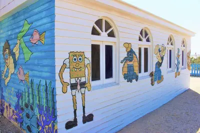 a building with a painting on the side of it at Rohanou Beach Resort in Quseir