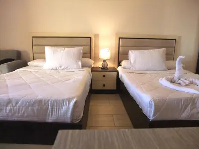a hotel room with two beds with stuffed animals on them at Sky Relax ALDAU HEIGHTS in Hurghada