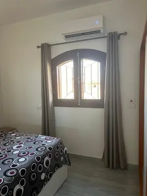 a bedroom with a bed and a window at Villa Muhammad in Quseir