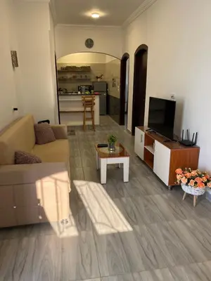 a living room with a couch and a tv and a table at Villa Muhammad in Quseir