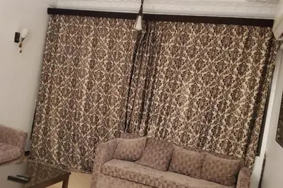 a living room with a couch and a curtain at Elminaa Residents 2 in Luxor