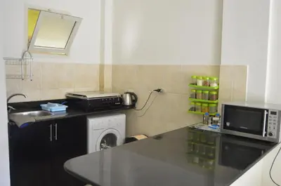 a kitchen with a counter top and a microwave at Nice 2-Bed Apartment in Hurghada