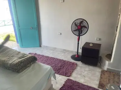 a bedroom with a bed and a fan in a room at Ziena marvel camp in Quseir