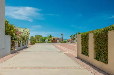 a walkway in a villa with a hedge at Stylish Nest - New Marina - El Gouna in Hurghada
