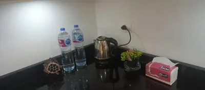 a counter with two bottles of water and a blender at Turtles Beach Resort in Hurghada