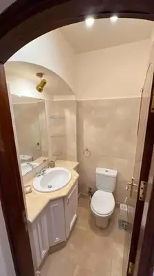 a bathroom with a white toilet and a sink at Vue magnifique, confort unique in Hurghada