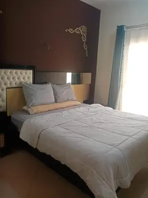 a large bed in a bedroom with a window at Family-friendly apartments in Hurghada in Hurghada