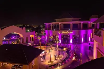 a building with purple lights on it at night at Hurghada Aldau Heights Studio in Hurghada