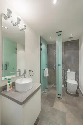 a bathroom with a sink and a toilet and a shower at Beach Front Paradise - 3 master beds - Abu Tig Marina - El Gouna in Hurghada