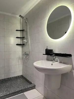 a white bathroom with a sink and a mirror at Casa De Madera - 1BR Sea & Golf View - Soma Bay in Hurghada