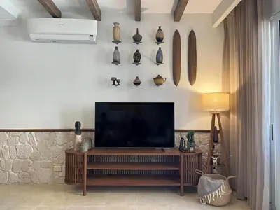 a living room with a flat screen tv on a wall at Casa De Madera - 1BR Sea & Golf View - Soma Bay in Hurghada