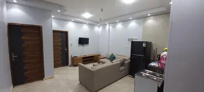a living room with a couch and a tv at Ikea flat 8 in Hurghada