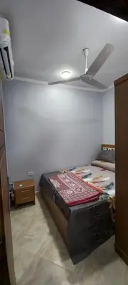 a bedroom with a bed and a ceiling fan at Ikea flat 8 in Hurghada