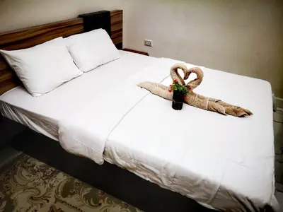 a bed with two towels on top of it at Relax Home 1 in Hurghada