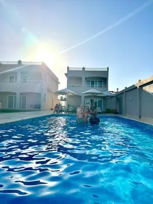 two people standing in a swimming pool at Royal Nile Suites - Luxury Nile View 2 in Luxor