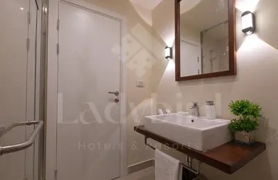 a bathroom with a white sink and a shower at Ladybird - Veranda Highline in Hurghada
