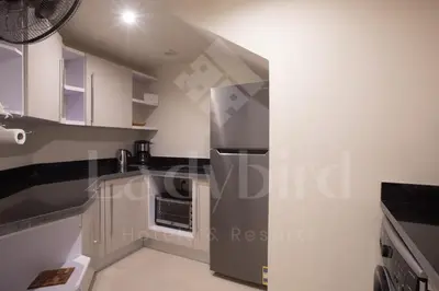 a kitchen with a stainless steel refrigerator in a room at Ladybird - Veranda Highline in Hurghada
