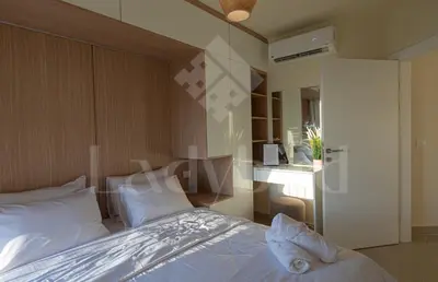 a bedroom with a bed with white pillows at Ladybird - Veranda Highline in Hurghada