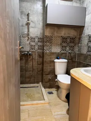 a bathroom with a toilet and a shower and a sink at Port Ghalib Apartments in Port Ghalib