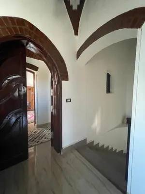 a hallway of a house with a door and a staircase at Villa Giulio - Guest House in Luxor