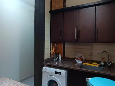 a kitchen with a sink and a washing machine at HW.Appartment in Hurghada