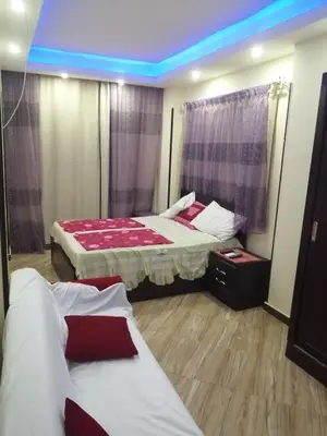 a bedroom with two beds and a blue ceiling at Apartment in Cecelia Resort in Hurghada