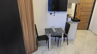 a small dining room table with two chairs and a television at Juliana beach in Hurghada