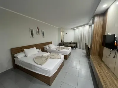 a hotel room with two beds and a television at Luxury Seaview Apartment with Pool Scandic Resort Hurghada in Hurghada