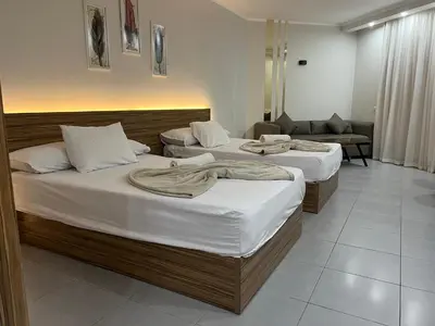 a room with two beds and a couch at Luxury Seaview Apartment with Pool Scandic Resort Hurghada in Hurghada