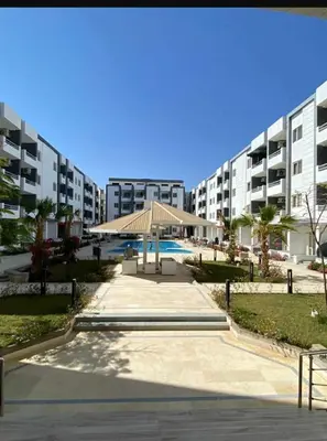 a large apartment building with a gazebo in a courtyard at Studio In sky el Gandoul compound in Hurghada