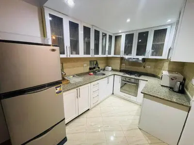 a kitchen with white cabinets and a refrigerator at Velký apartmán 50 m od pláže s přístupem zdarma- Sahl Hasheesh Hurghada resort Andalusie in Hurghada