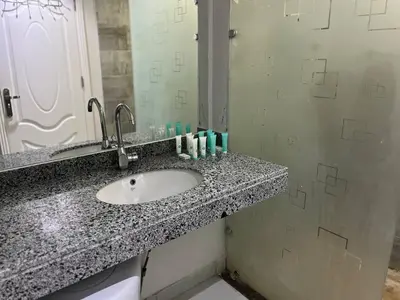 a bathroom counter with a sink and a mirror at Scandic Resort in Hurghada