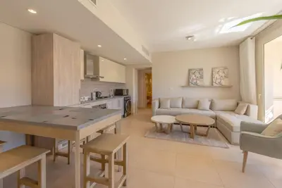 a kitchen and living room with a couch and a table at Modern 1BR, Mangroovy, Gouna - 1BR, Pool, & Beach in Hurghada